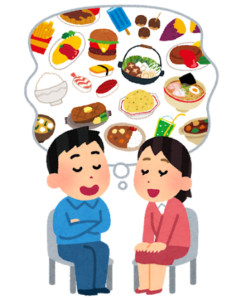 様々な食べ物を思い浮かべる、椅子に座った男性と女性