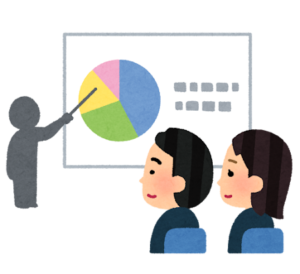 プレゼンテーションを聞くスーツ姿の聴衆